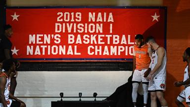 Players next to championship banner