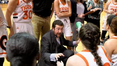 Coach James Jackson speaks to team during a timeout