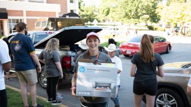 Student Carries Belongings into Dorm