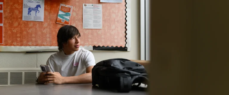 Student looking out window in the Asher Science Center.